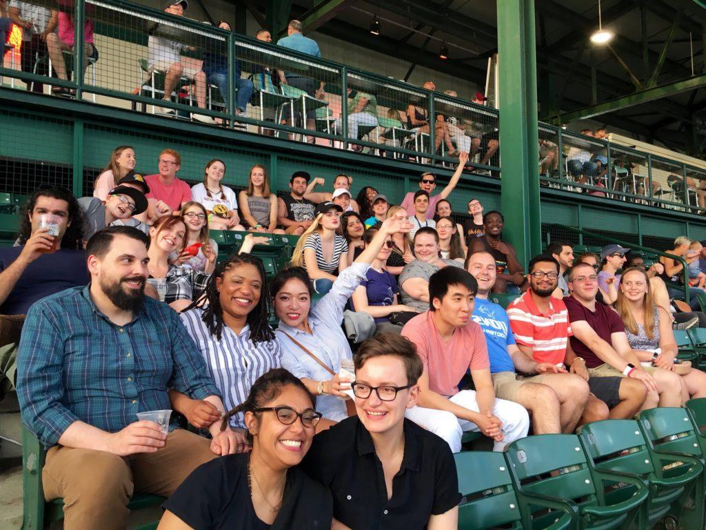 A group of University of Rochester graduate students attending a Rochester Red Wings baseball game on Pride Night.