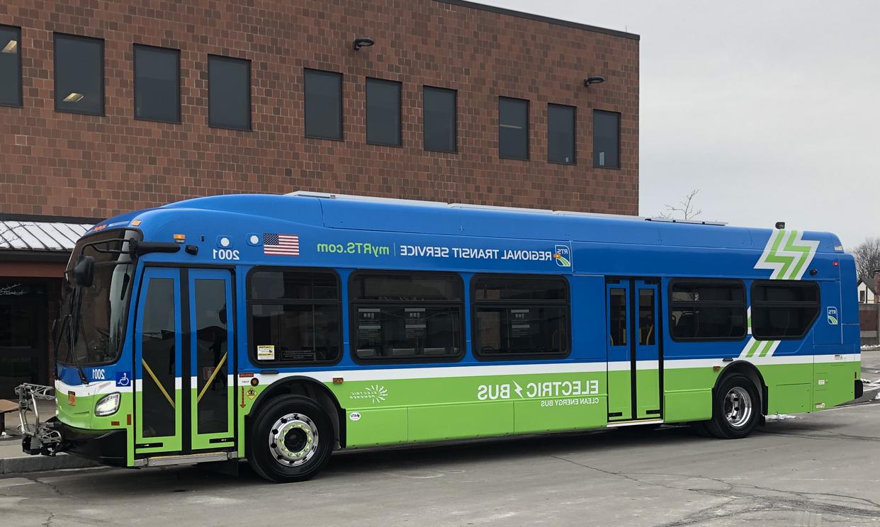 Blue and green RTS electric bus on city street