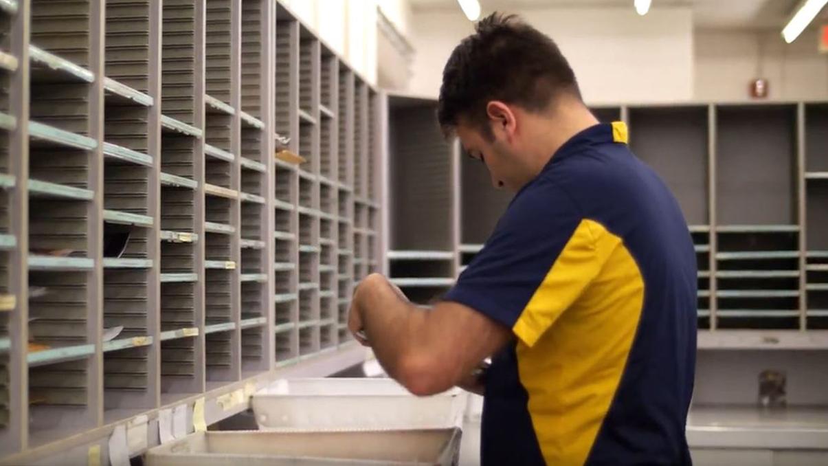 Employee sorting mail.