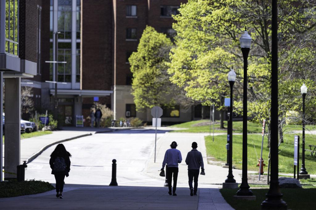 Students walk past Rush Rhees Library towards Susan B Anthony Hall